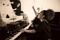 a black and white photo of a woman playing a keyboard